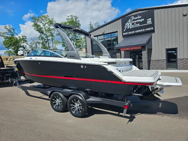 Slide: The Image of 2025 Four Winns H4 boat on trailer at Premier Advantage Marine dealership. - 2