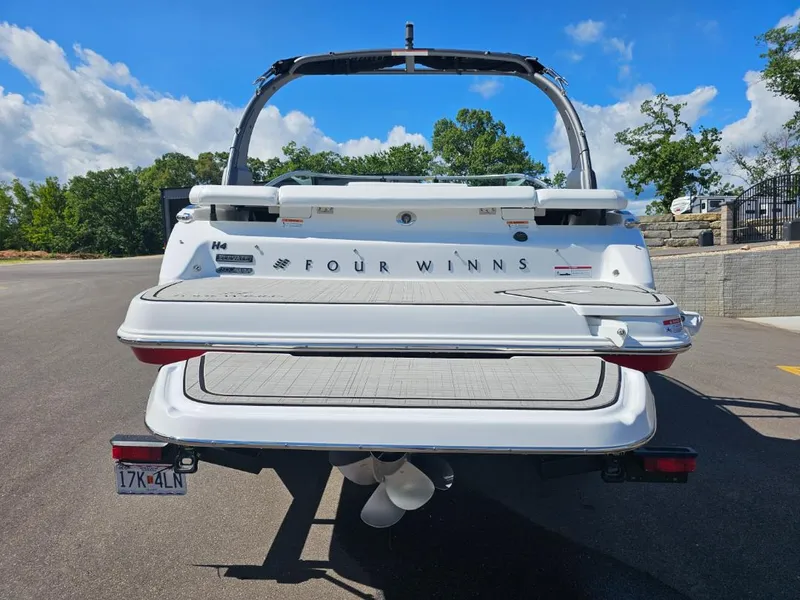 Slide: The Image of 2025 Four Winns H4 boat rear view with swim platform and wakeboard tower. - 3