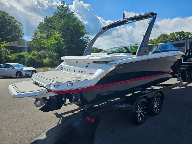 Slide: The Image of 2025 Four Winns H4 boat on a trailer, rear view, outdoors. - 4