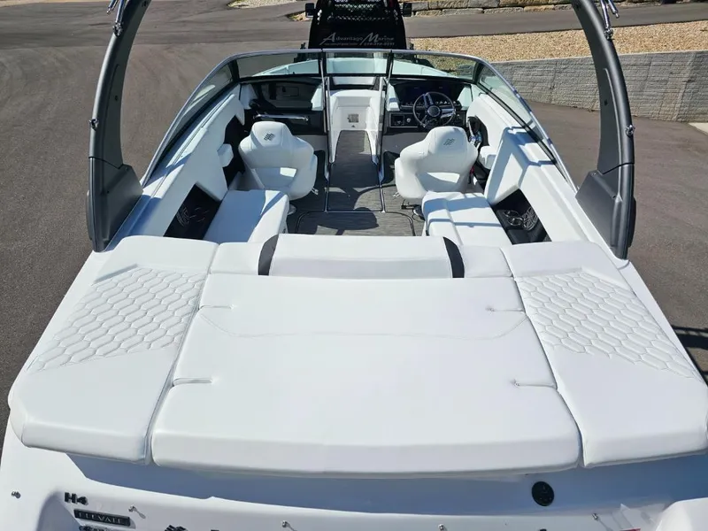 Slide: The Image of 2025 Four Winns H4 boat interior with white seating and modern dashboard. - 7
