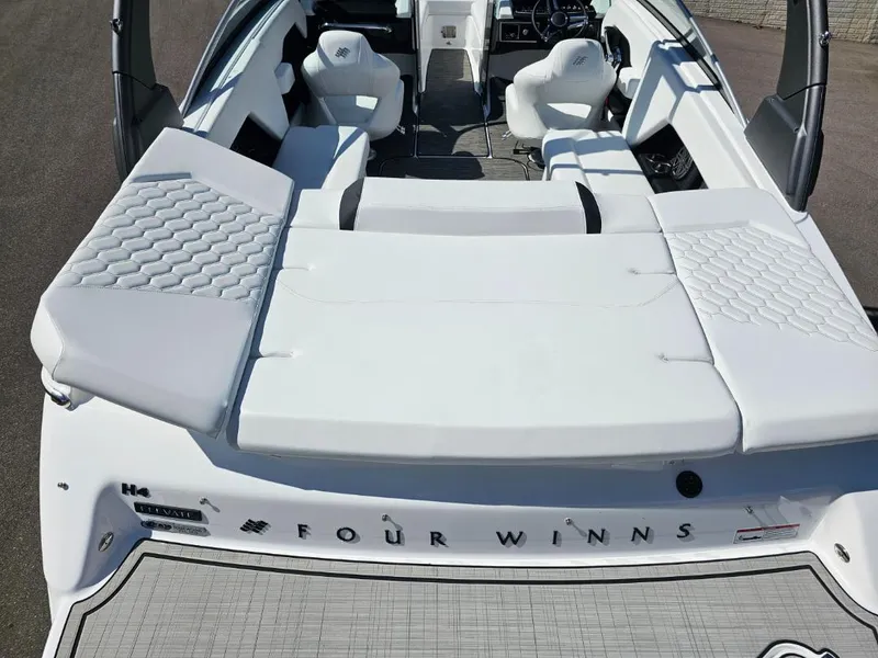 Slide: The Image of 2025 Four Winns H4 boat interior with white seating and sun pad. - 8