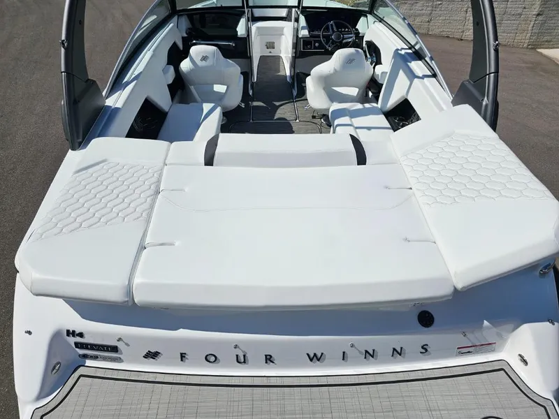 Slide: The Image of 2025 Four Winns H4 boat interior with white seating and modern design. - 9