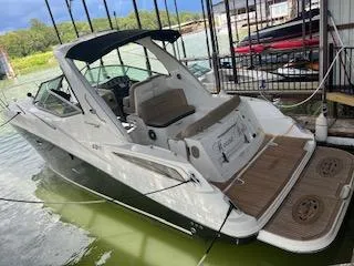 The Image of 2016 Sea Ray 330 Sundancer docked, featuring sleek design and spacious deck area. - 0