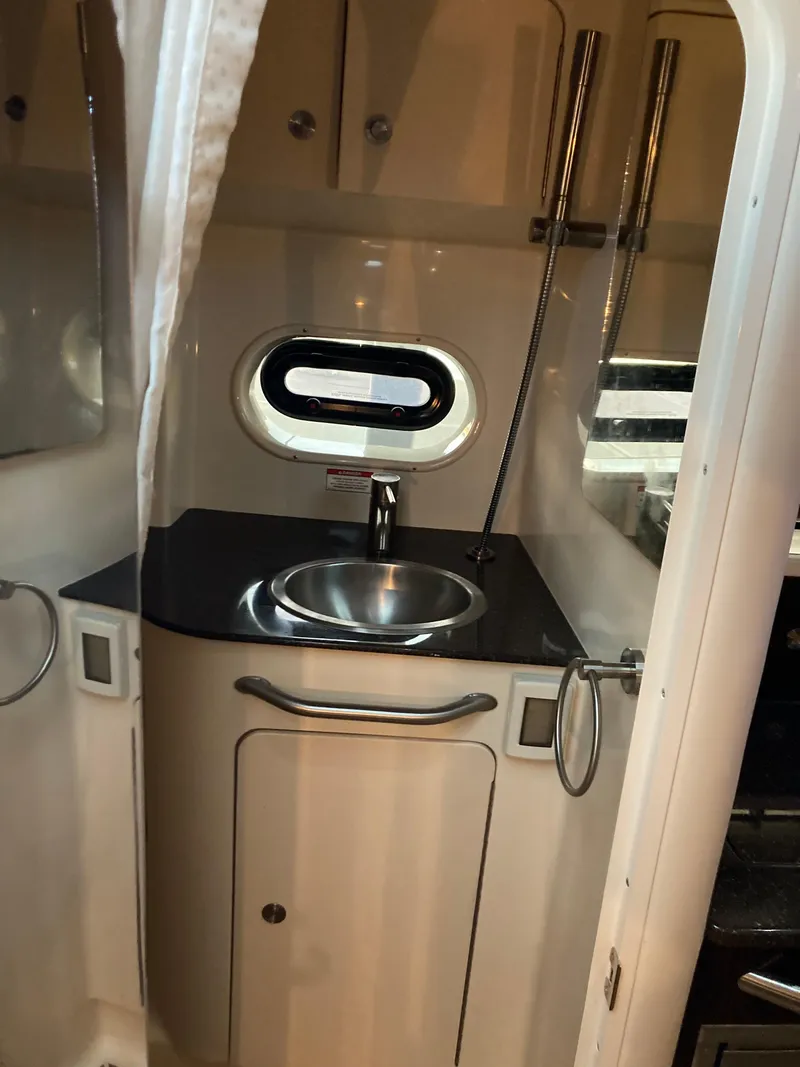 Slide: The Image of 2016 Sea Ray 330 Sundancer bathroom with sink and porthole window. - 13
