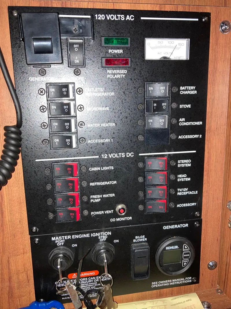 Slide: The Image of Control panel of a 2016 Sea Ray 330 Sundancer boat, featuring various switches and indicators. - 14