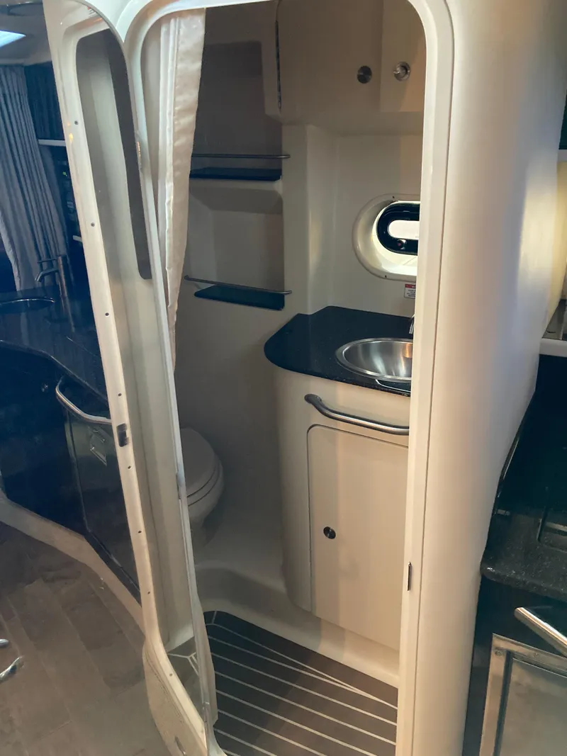 Slide: The Image of 2016 Sea Ray 330 Sundancer bathroom interior with sink and toilet. - 15