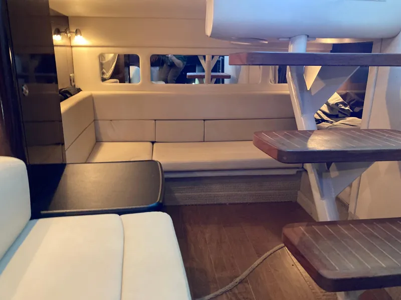 Slide: The Image of Interior of 2016 Sea Ray 330 Sundancer with beige seating and wooden steps. - 16