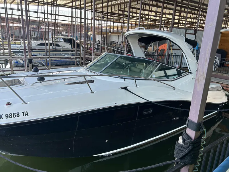 Slide: The Image of 2016 Sea Ray 330 Sundancer docked in a marina, featuring sleek design and modern amenities. - 2