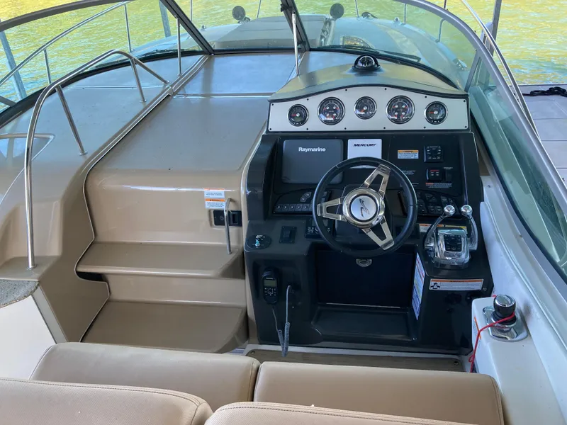 Slide: The Image of 2016 Sea Ray 330 Sundancer helm with modern controls and steering wheel. - 22