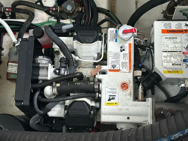 Slide: The Image of Engine compartment of a 2016 Sea Ray 330 Sundancer boat, showcasing mechanical components. - 23