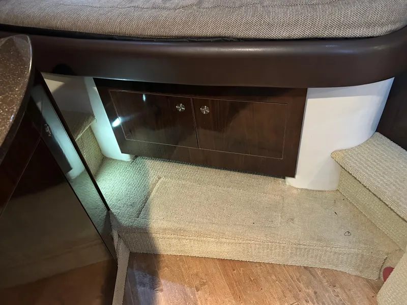 Slide: The Image of Interior of 2016 Sea Ray 330 Sundancer with wooden cabinet and carpeted steps. - 28