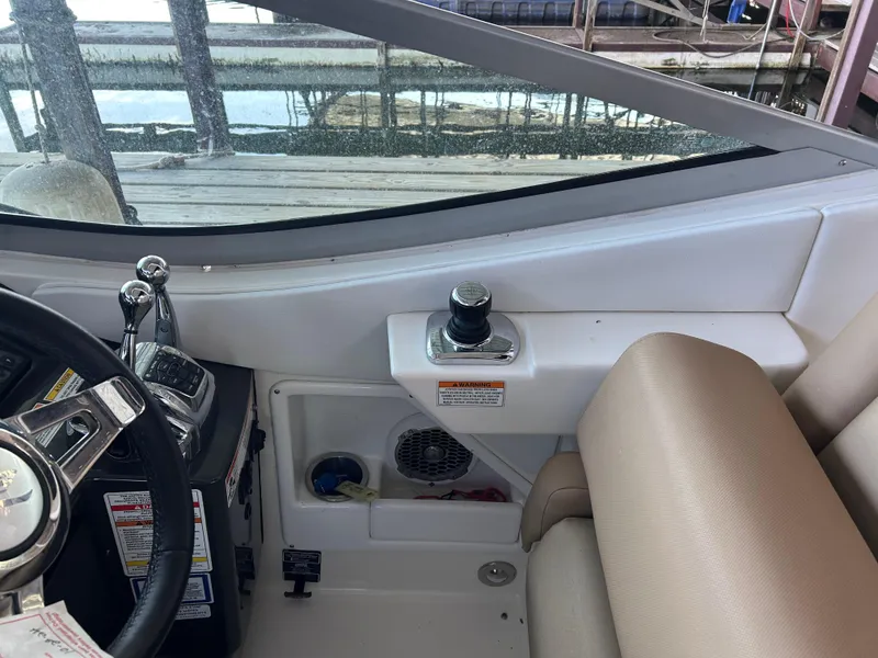 Slide: The Image of Interior view of a 2016 Sea Ray 330 Sundancer boat cockpit with steering controls. - 34