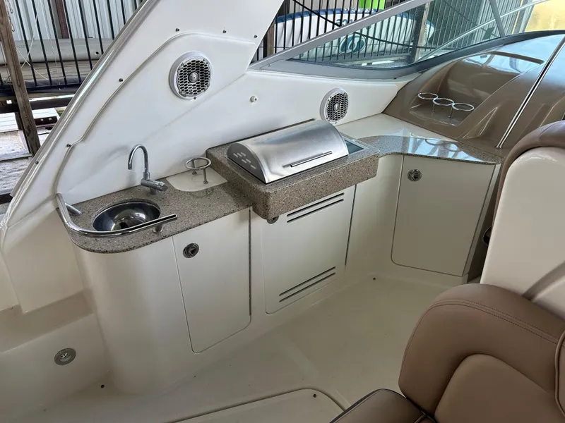 Slide: The Image of 2016 Sea Ray 330 Sundancer boat interior with kitchenette, sink, and grill. - 37