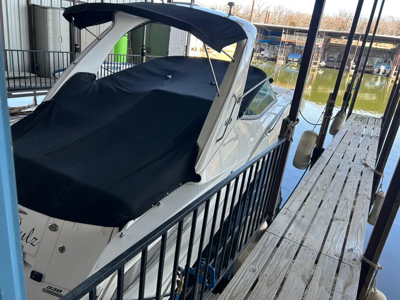 Slide: The Image of 2016 Sea Ray 330 Sundancer docked with black cover, marina setting. - 40