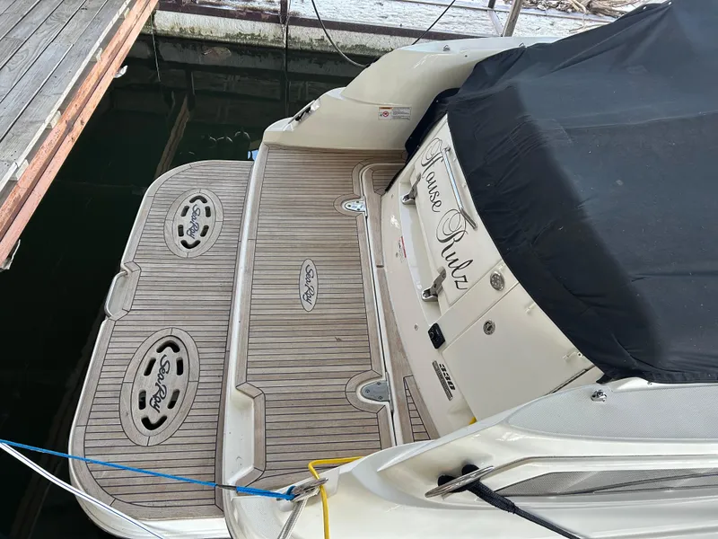 Slide: The Image of 2016 Sea Ray 330 Sundancer docked, featuring teak swim platform and covered seating area. - 41