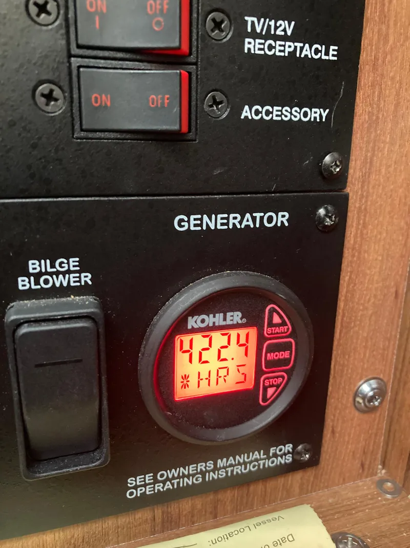 Slide: The Image of Control panel of a 2016 Sea Ray 330 Sundancer showing 424 generator hours. - 8