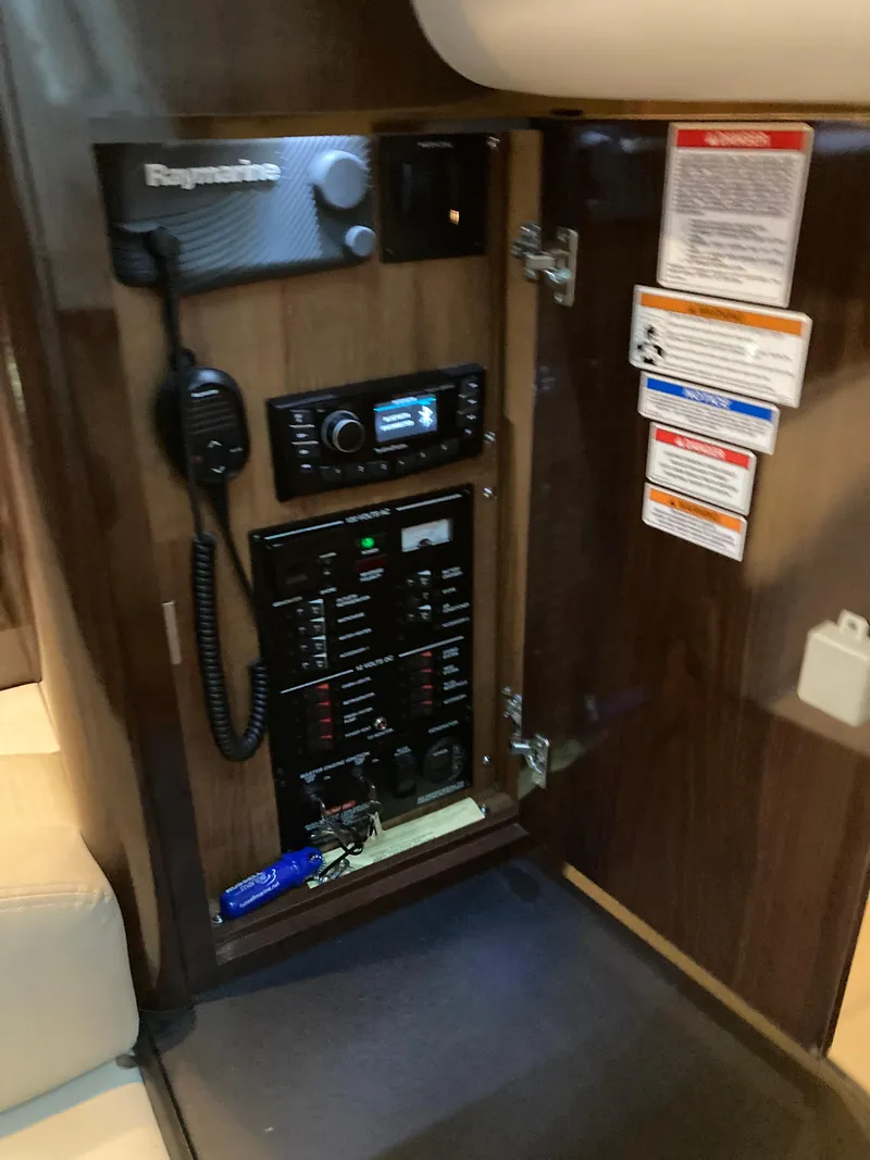 Slide: The Image of Control panel inside 2016 Sea Ray 330 Sundancer boat, featuring Raymarine equipment. - 9