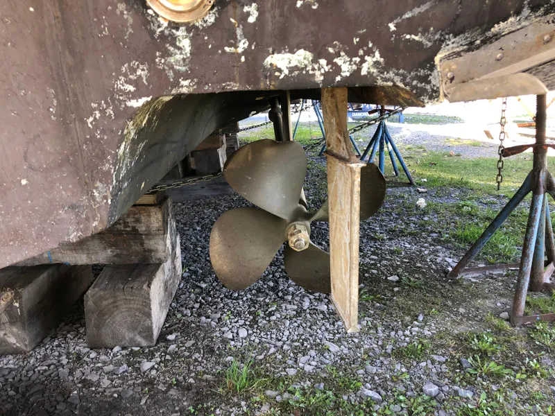 Slide: The Image of Propeller of 1995 Sea Ray 450 Sundancer on dry dock, showing wear and support structures. - 11