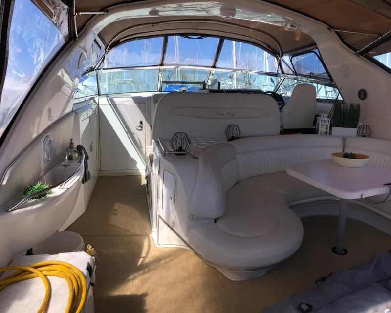 Slide: The Image of Interior of 1995 Sea Ray 450 Sundancer yacht with white seating and table. - 13