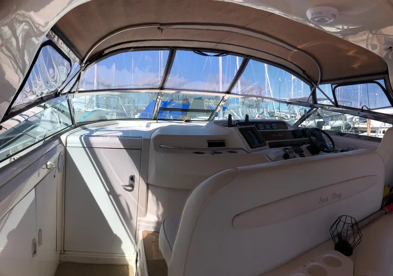 Slide: The Image of Interior view of a 1995 Sea Ray 450 Sundancer yacht cockpit with steering wheel and controls. - 14