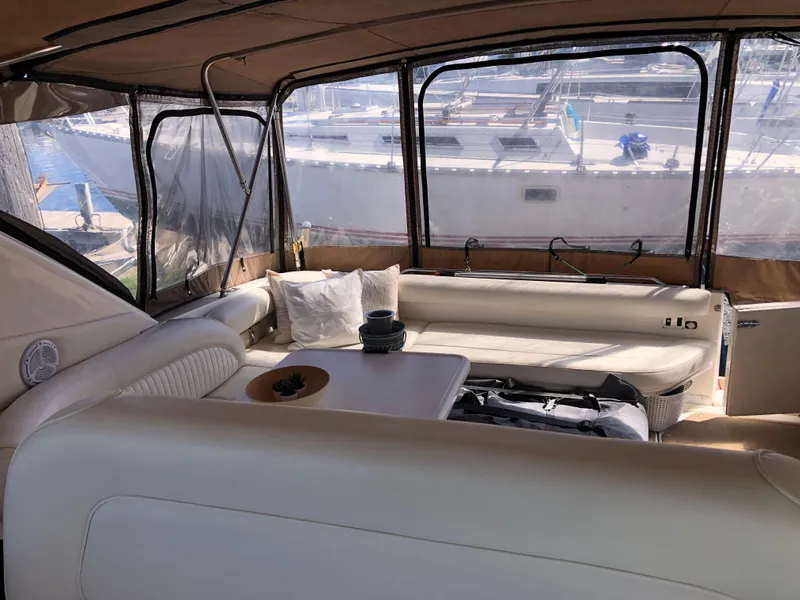 Slide: The Image of Interior of a 1995 Sea Ray 450 Sundancer yacht with comfortable seating and marina view. - 16