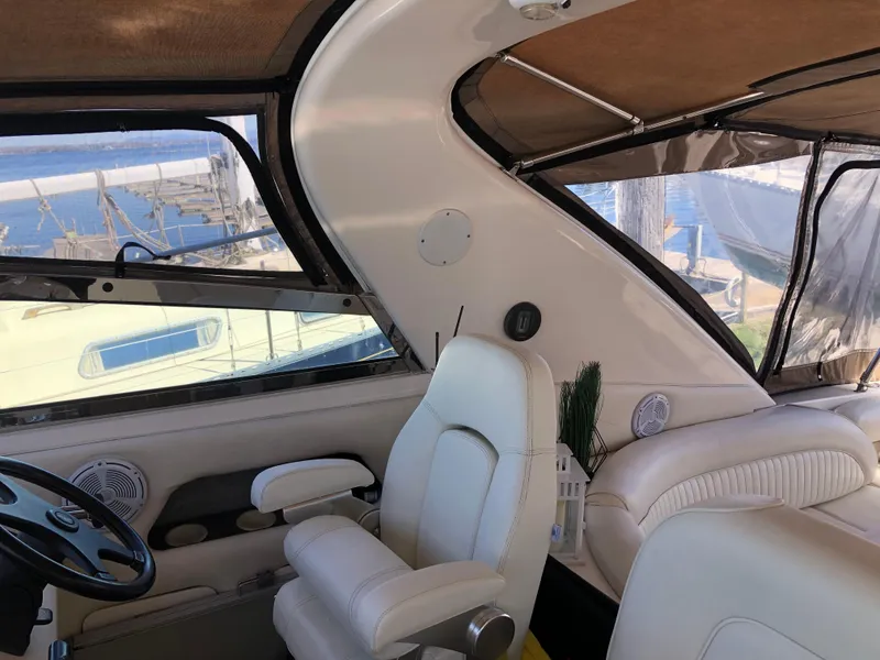 Slide: The Image of Interior view of a 1995 Sea Ray 450 Sundancer yacht with white seating and helm. - 17