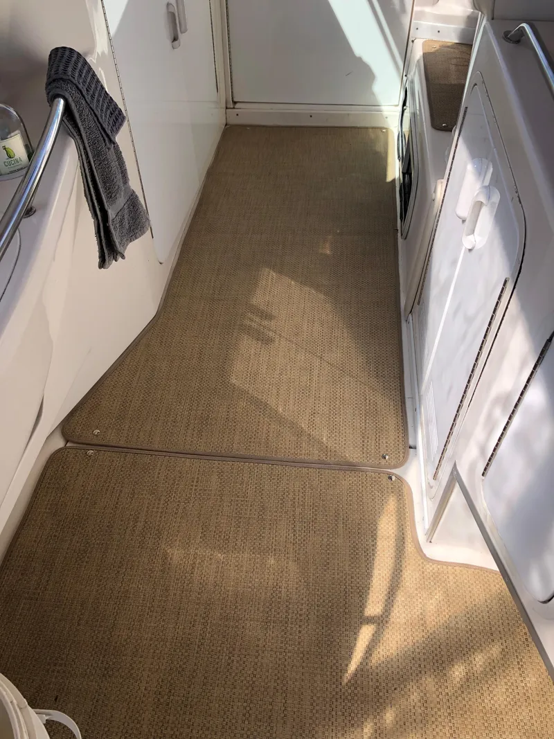 Slide: The Image of Interior view of 1995 Sea Ray 450 Sundancer with beige carpet and white cabinetry. - 20