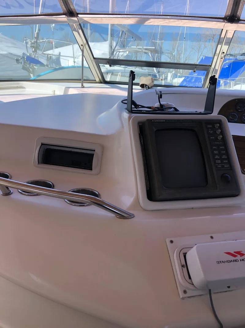 Slide: The Image of 1995 Sea Ray 450 Sundancer helm with navigation equipment and windshield view. - 22