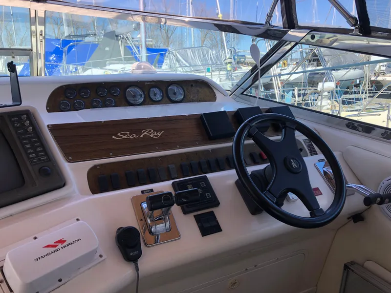 Slide: The Image of 1995 Sea Ray 450 Sundancer helm with steering wheel and control panel. - 23