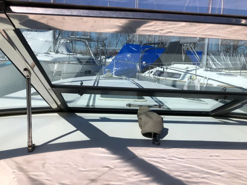 Slide: The Image of 1995 Sea Ray 450 Sundancer yacht interior view with marina background. - 24