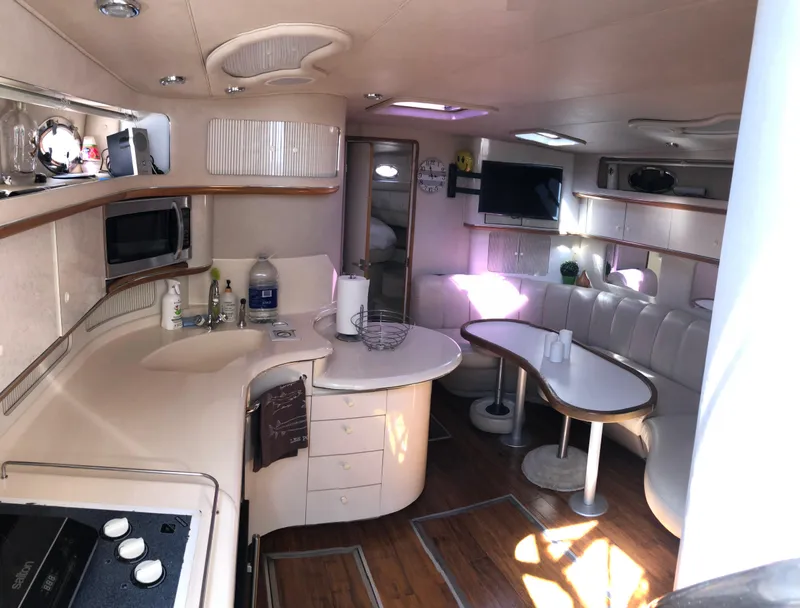 Slide: The Image of Interior of 1995 Sea Ray 450 Sundancer yacht with kitchen and seating area. - 28