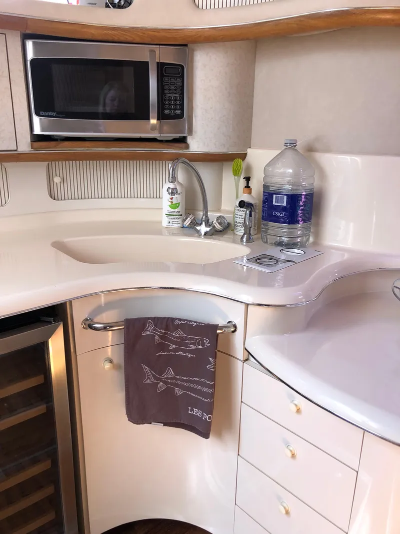 Slide: The Image of Interior of 1995 Sea Ray 450 Sundancer yacht kitchen with microwave and sink. - 33