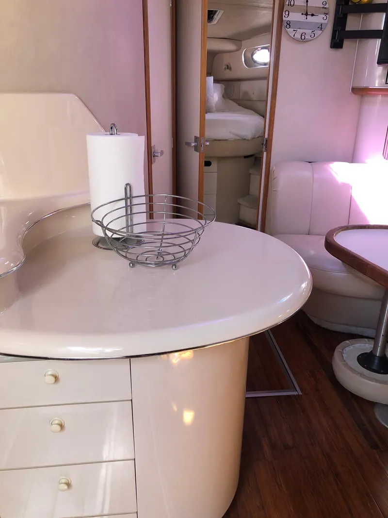 Slide: The Image of Interior of 1995 Sea Ray 450 Sundancer yacht with modern kitchen and seating area. - 34
