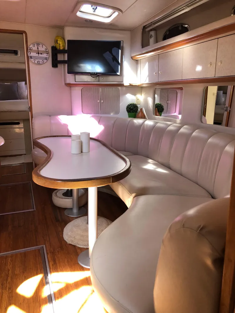 Slide: The Image of Interior of 1995 Sea Ray 450 Sundancer yacht with plush seating and modern amenities. - 36