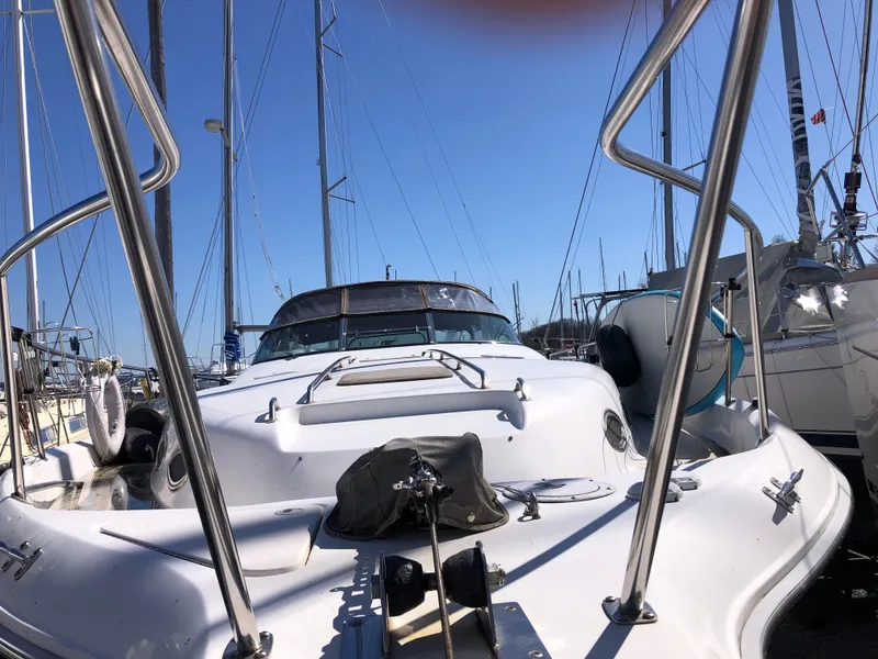 Slide: The Image of 1995 Sea Ray 450 Sundancer yacht docked at marina, clear blue sky background. - 4