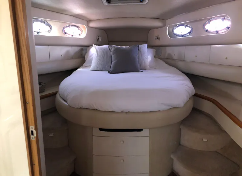 Slide: The Image of Luxurious cabin interior of 1995 Sea Ray 450 Sundancer with cozy bed and porthole windows. - 40