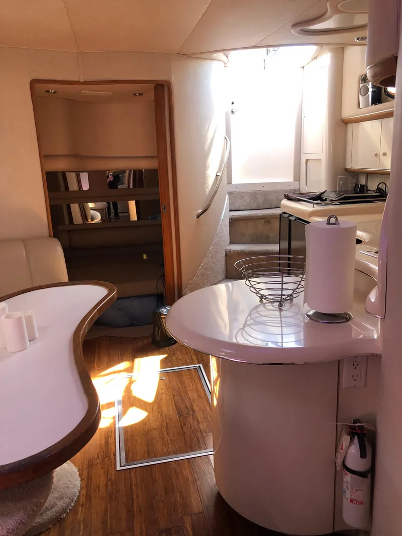 Slide: The Image of Interior of 1995 Sea Ray 450 Sundancer yacht with modern kitchen and seating area. - 42