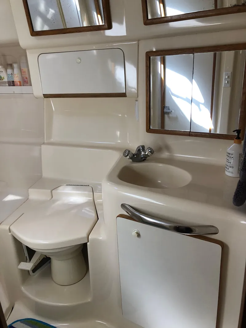 Slide: The Image of Bathroom interior of 1995 Sea Ray 450 Sundancer yacht, featuring sink and toilet. - 43