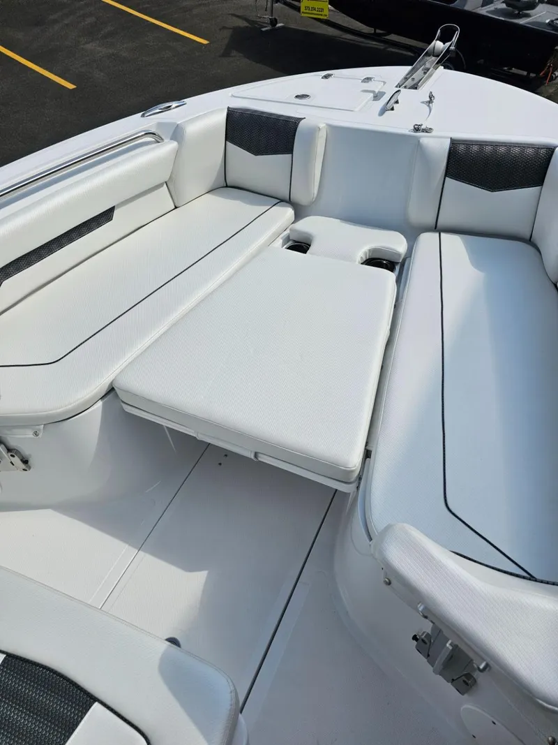 Slide: The Image of 2025 Wellcraft 223 Fisherman boat interior with white cushioned seating. - 14