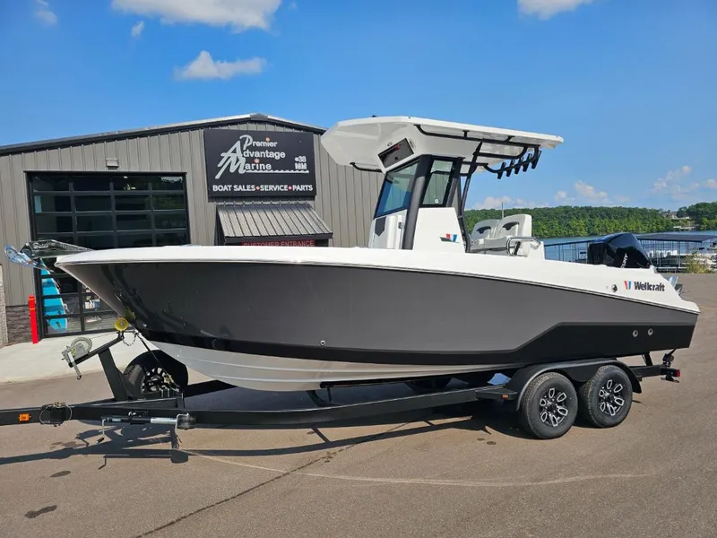 The Image of 2025 Wellcraft 243 Fisherman boat on trailer outside dealership. - 1