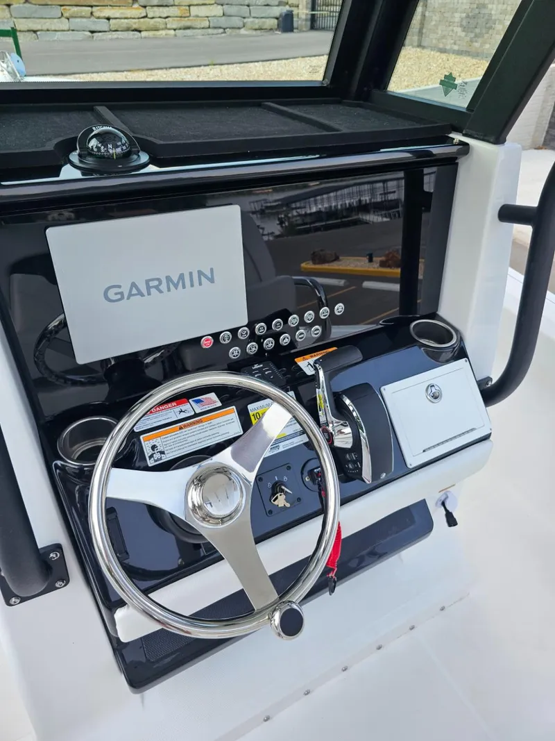 Slide: The Image of 2025 Wellcraft 243 Fisherman boat dashboard with Garmin navigation system. - 11