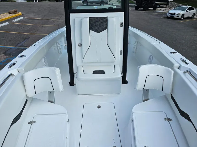 Slide: The Image of 2025 Wellcraft 243 Fisherman boat interior with white seating and storage compartments. - 14