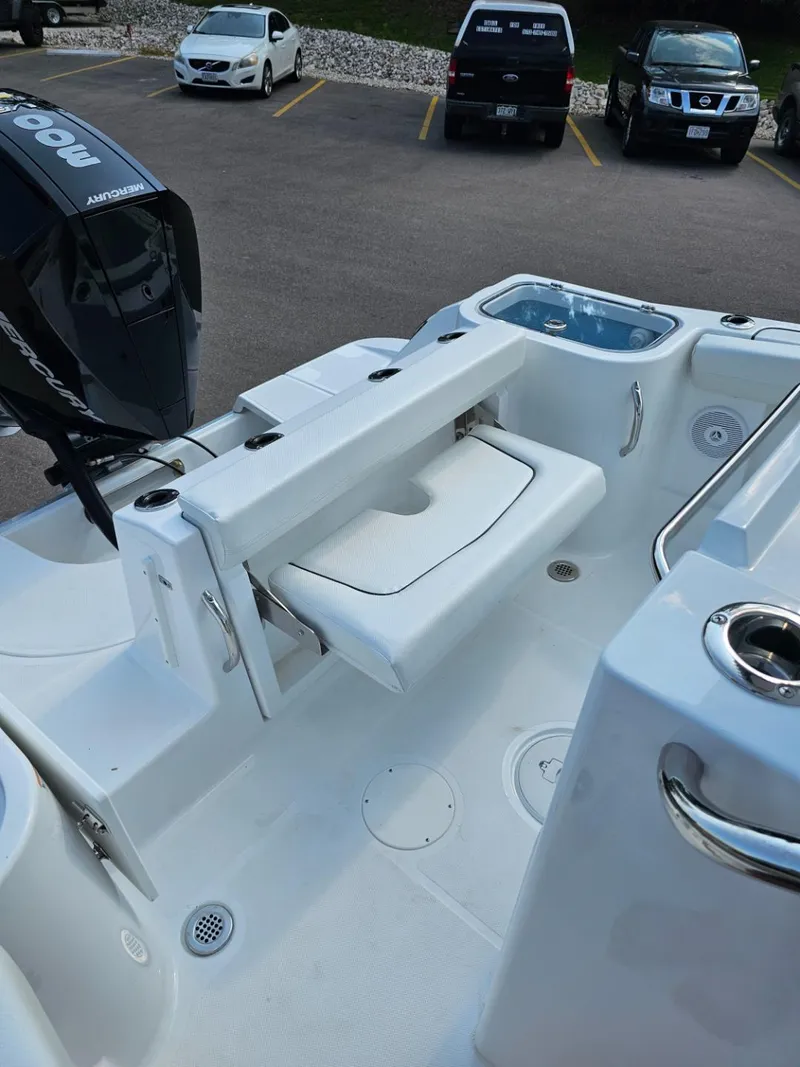 Slide: The Image of 2025 Wellcraft 243 Fisherman boat interior with seating and motor. - 18