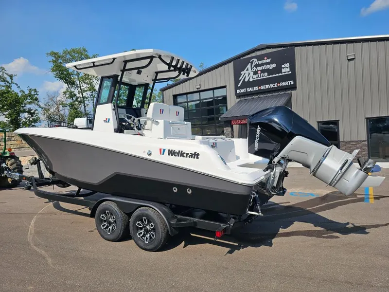 Slide: The Image of 2025 Wellcraft 243 Fisherman boat on trailer outside dealership. - 2