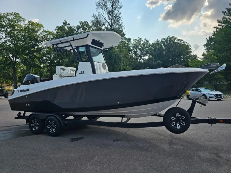 Slide: The Image of 2025 Wellcraft 243 Fisherman boat on a trailer in a parking lot. - 5