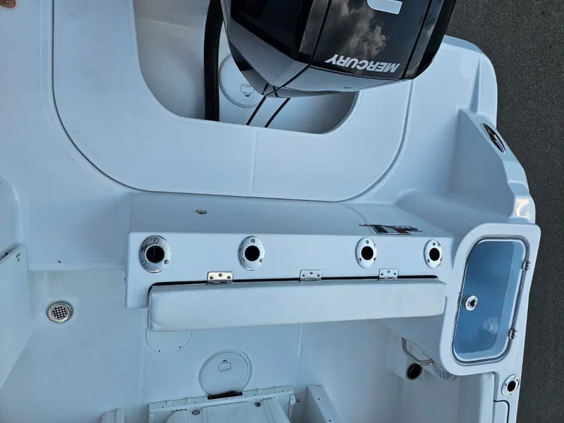 Slide: The Image of 2025 Wellcraft 243 Fisherman boat deck with Mercury engine and fishing rod holders. - 6