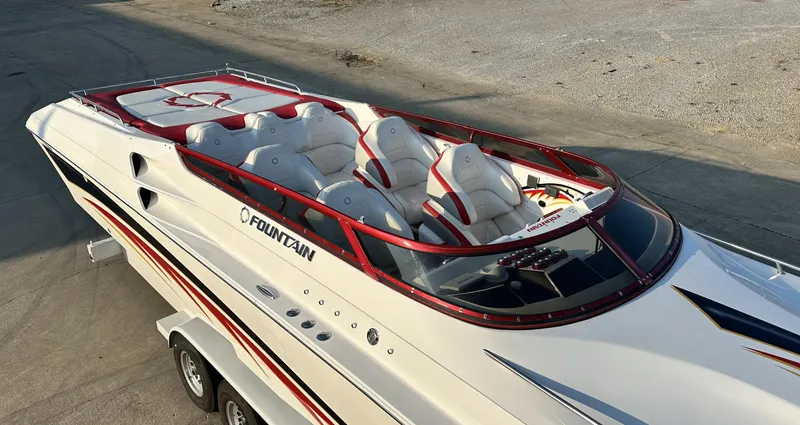 Slide: The Image of 2007 Fountain 47 Lightning speedboat with sleek design and red accents on a trailer. - 19