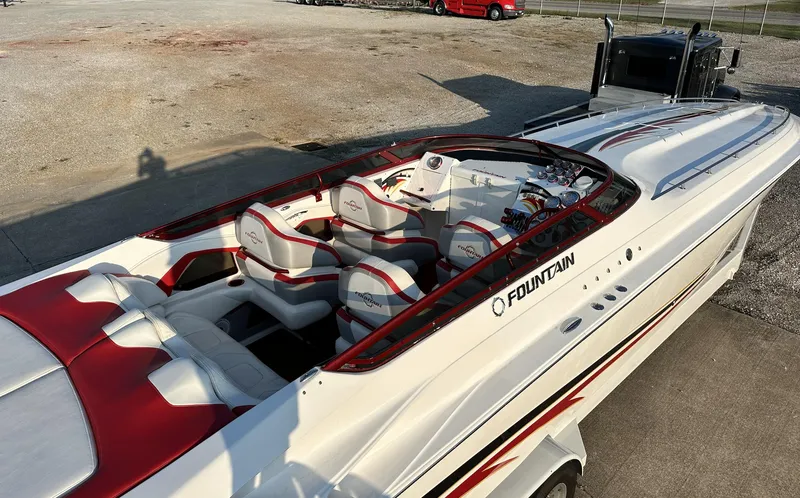 Slide: The Image of 2007 Fountain 47 Lightning speedboat with red and white interior, parked on concrete. - 20