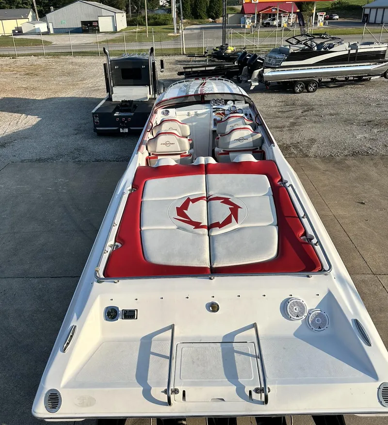 Slide: The Image of 2007 Fountain 47 Lightning speedboat with red and white seating, parked on a concrete surface. - 21