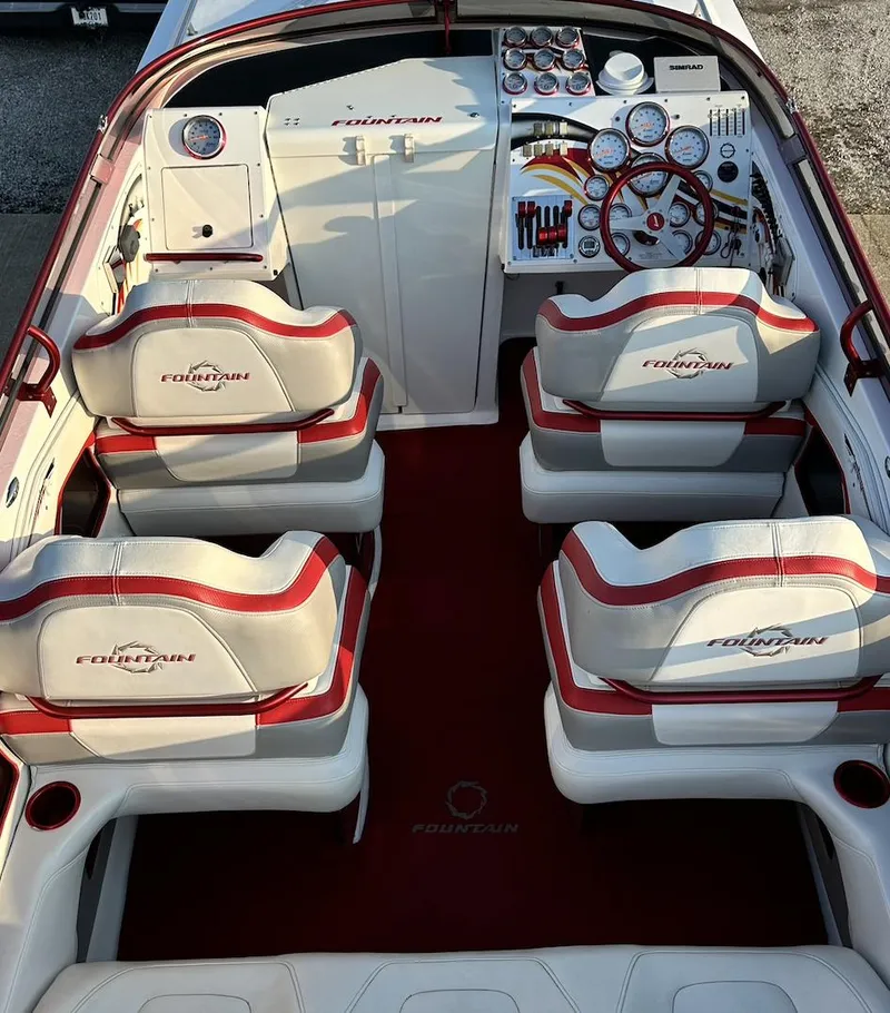 Slide: The Image of 2007 Fountain 47 Lightning boat interior with red and white seating and detailed dashboard. - 23